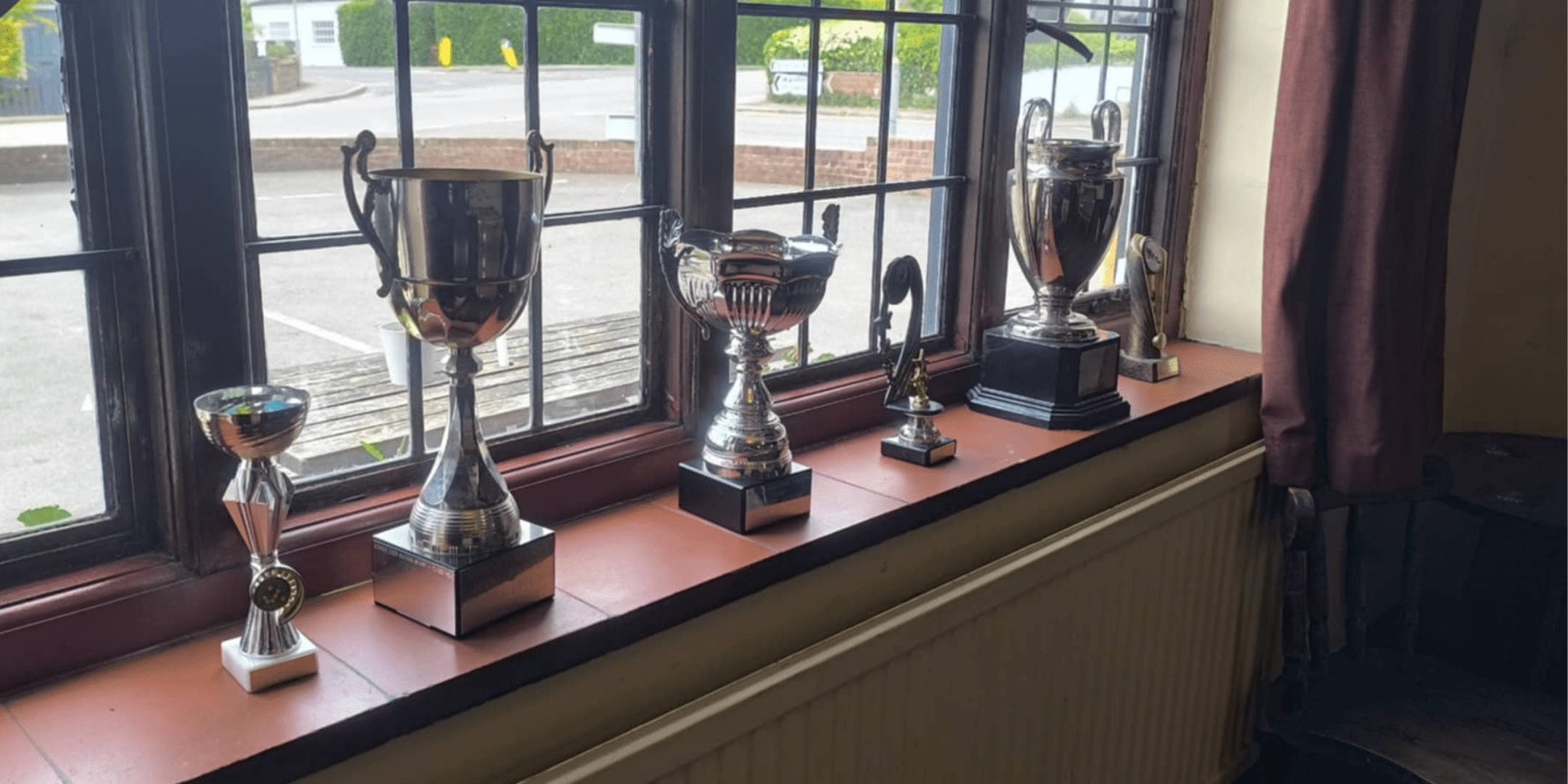 Award trophies on display at The Dukes Head pub in Hamstreet, showcasing local recognition and community pride