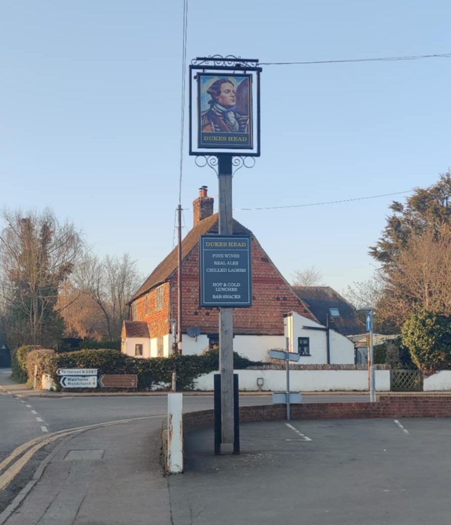 Traditional pub sign outside The Dukes Head in Hamstreet, Kent, welcoming visitors to this country pub